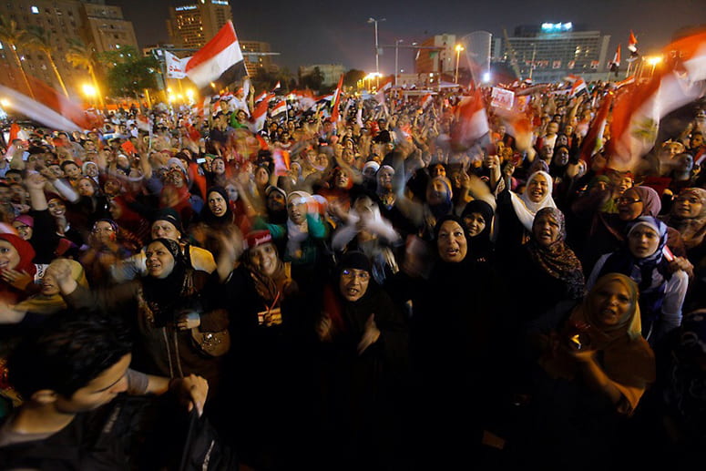 Protesters in Tahrir Square waving flags