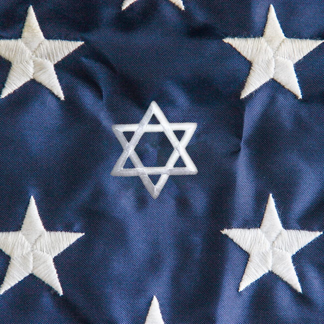 Detail image of the stars on an American flag, with one star replaced with the Star of David
