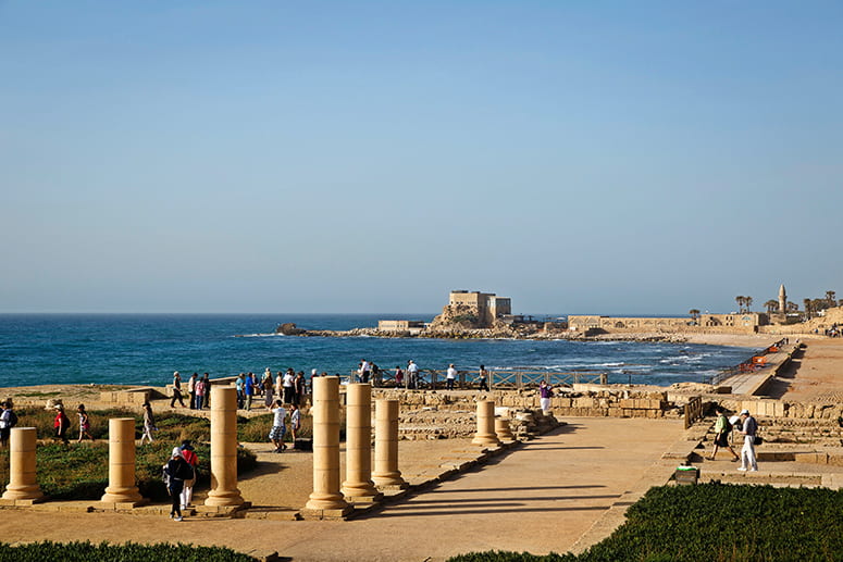 Photo of tourtists exploring the ruins at Caesarea