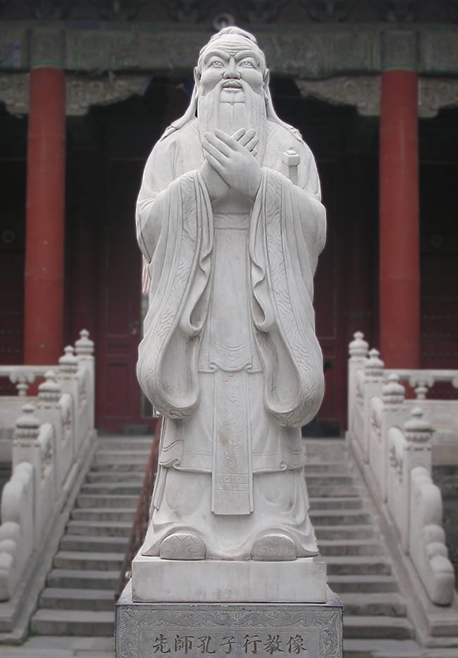 Stone statue of Confucius at the entrance to a temple