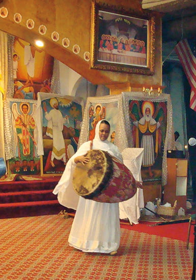 Photo of a female drummer inside the church