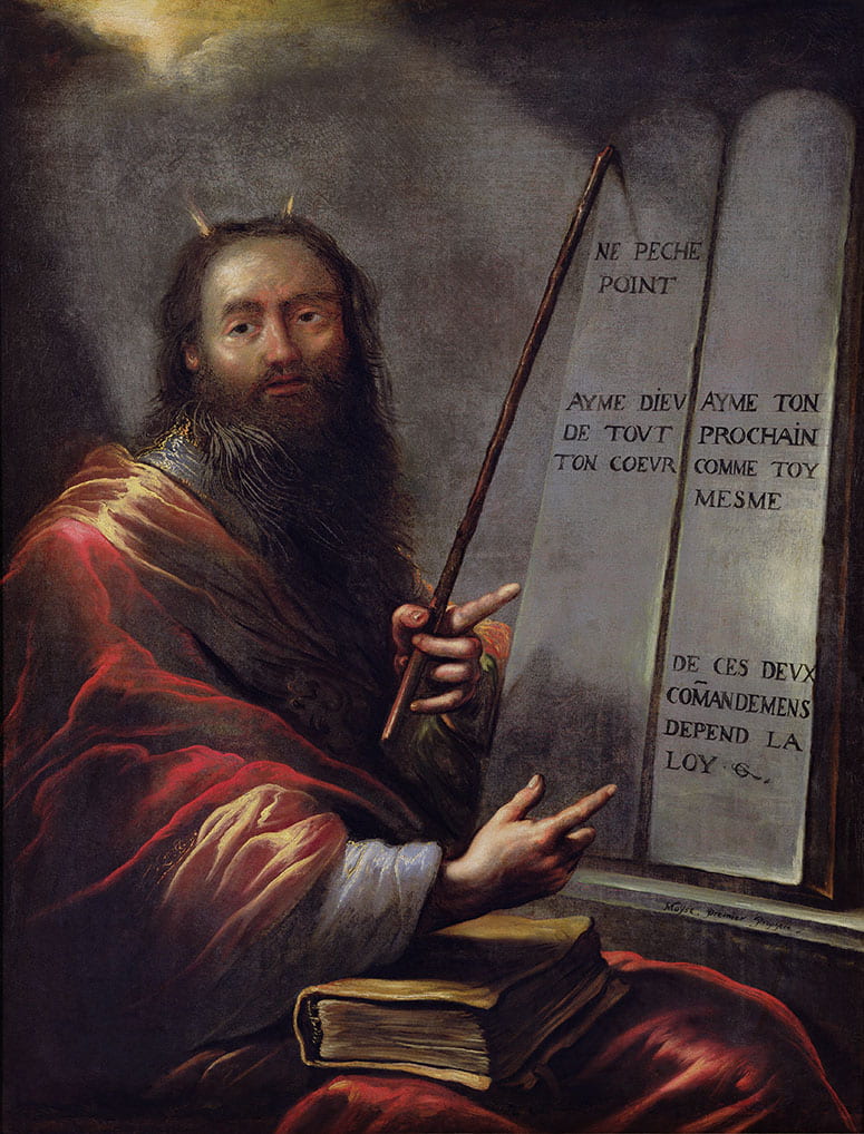 Painting of seated Moses, with small horns, with a book on his lap and pointing to a tablet of law