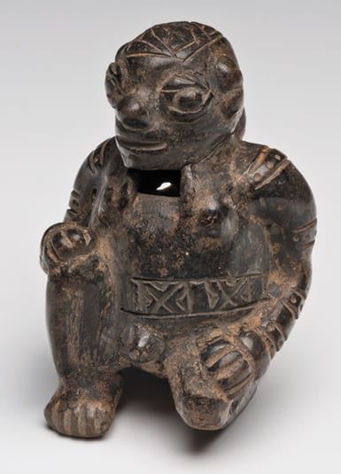 Photo of an ocarina shaped like a kneeling male figure