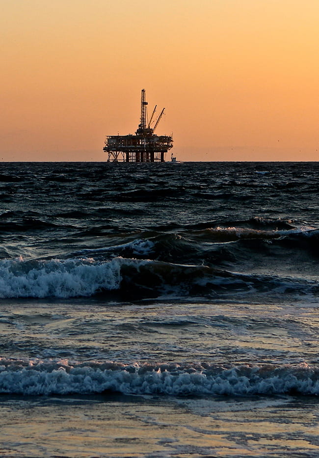 Oil Rig on the horizon in the Gulf Coast at dawn