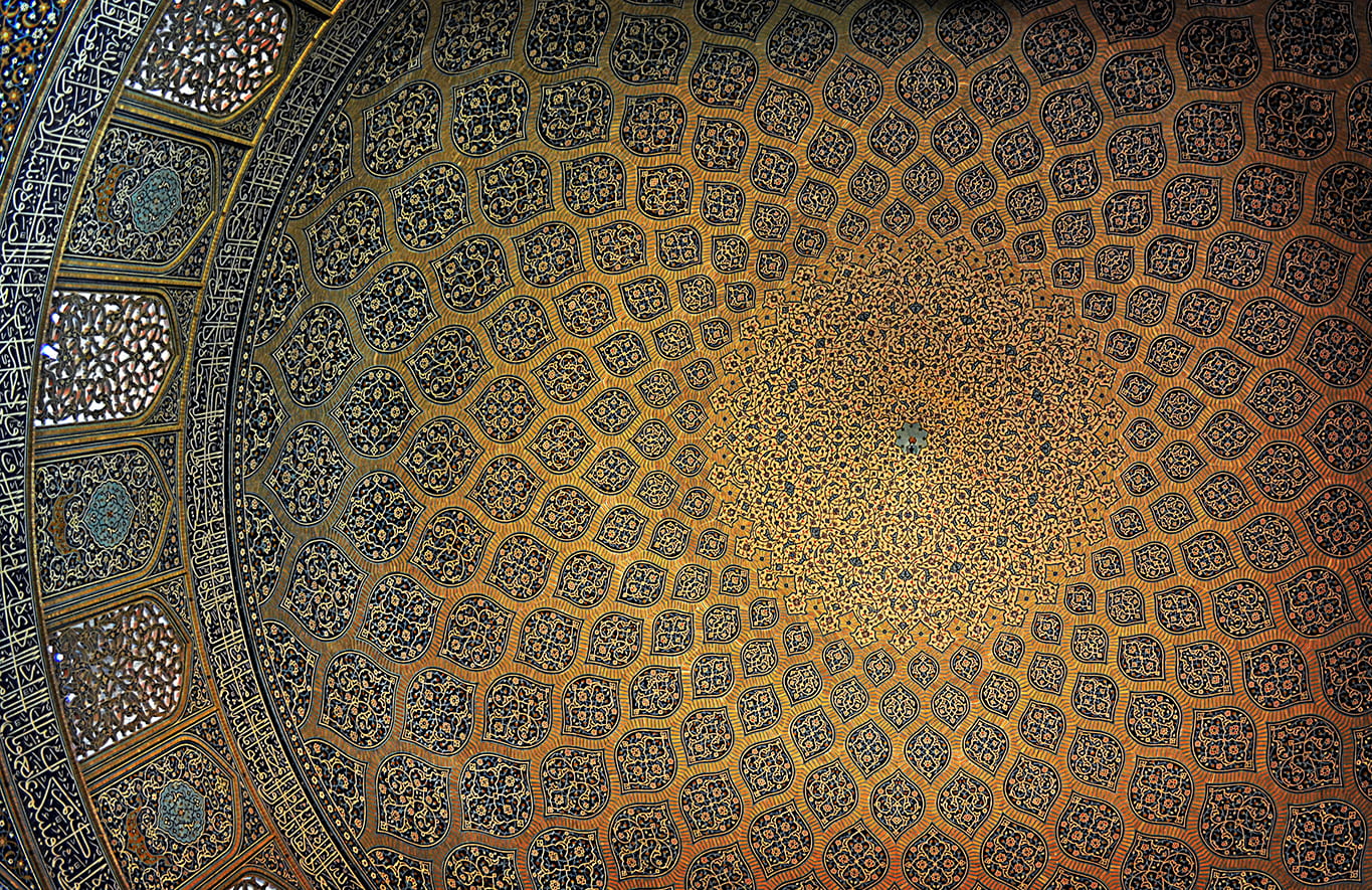 Photo looking up at the inside of a mosque dome