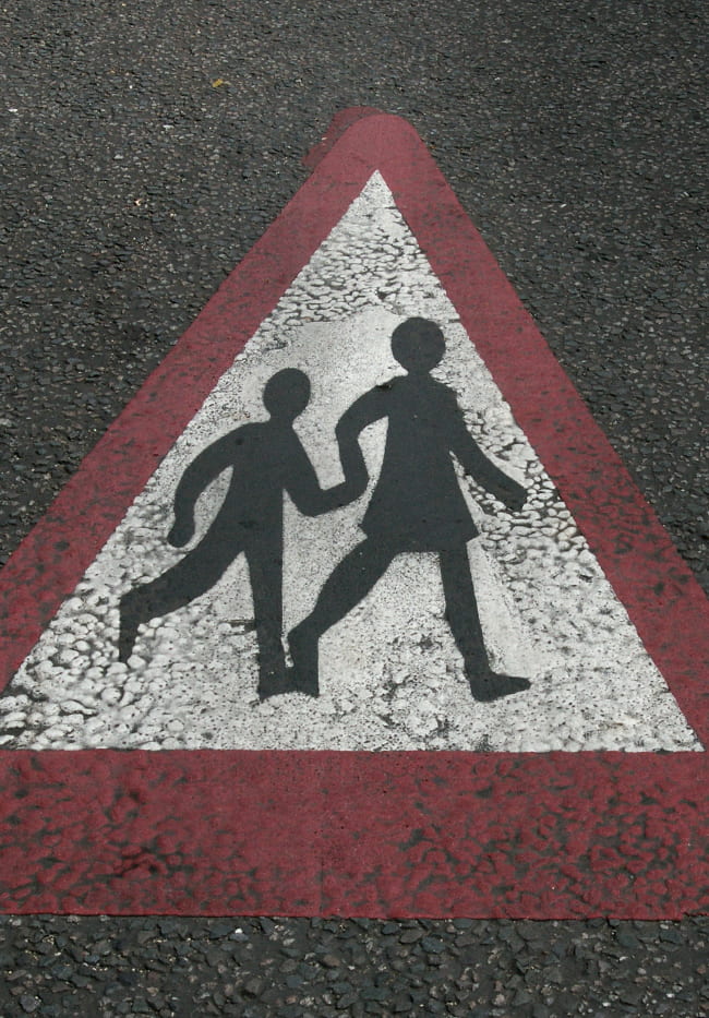 Photo of mother and child street crossing symbol painted on a street