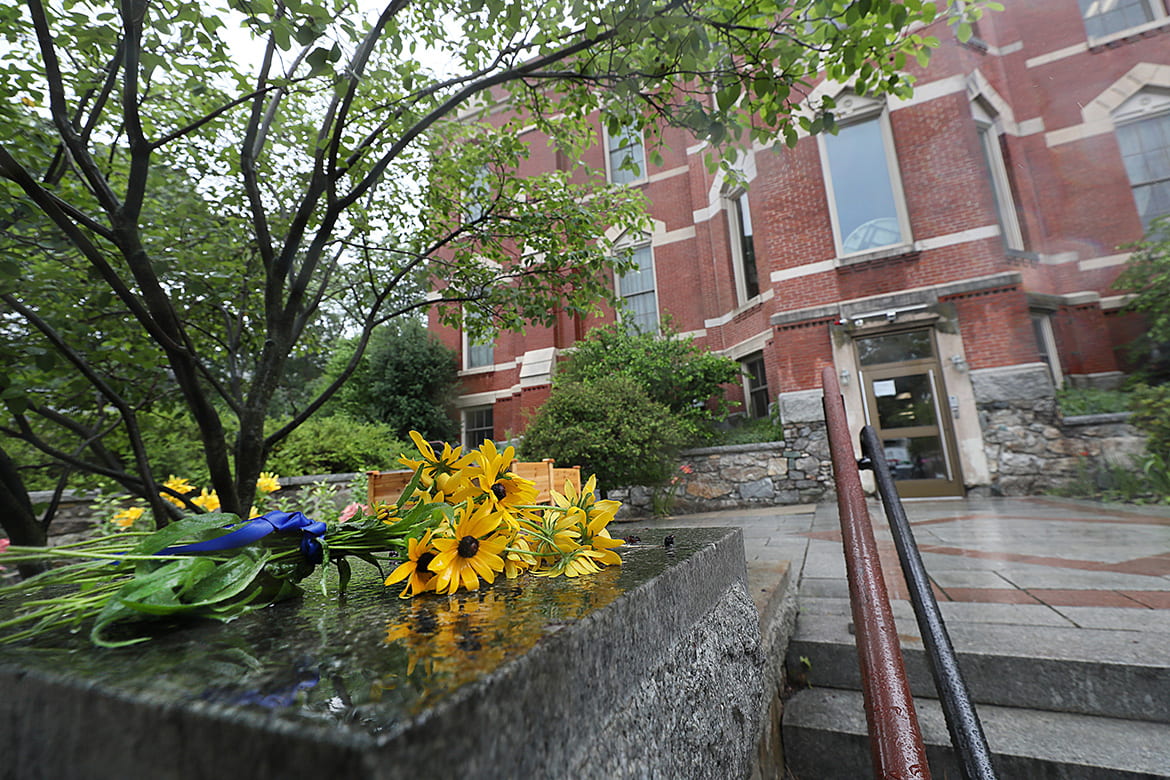 A bouquet of flowers laying next to the entrance steps to Shaloh House