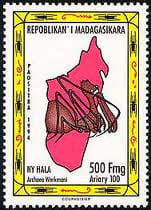 Postage stamp with drawing of a spider superimposed on an outline of Madagascar