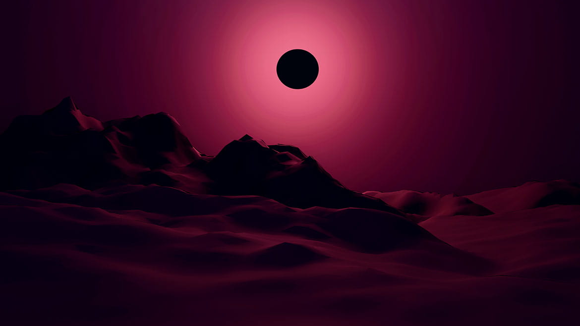 Eclipse over a red mountain landscape