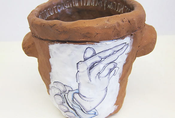 Clay vessel with Hebrew inscription inside and drawing of a hand raised in a gesture of blessing on the outside