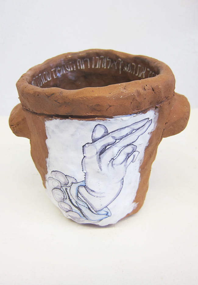 Clay vessel with Hebrew inscription inside and a hand with pinched fingers drawn on the outside